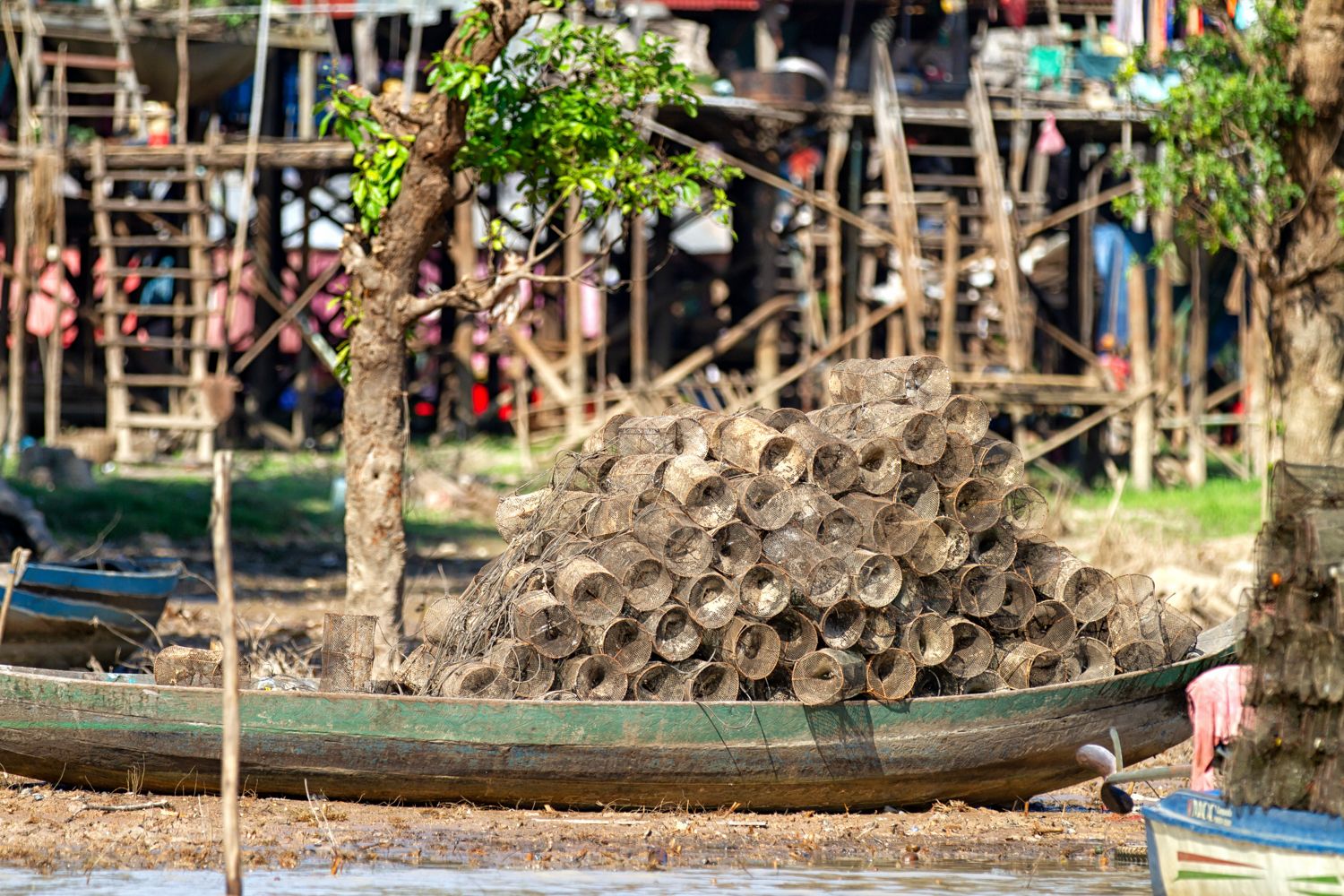 Many small fishing traps on a wood boat in Kampong Phluk on Tonle Sap lake waiting to be used for fishing