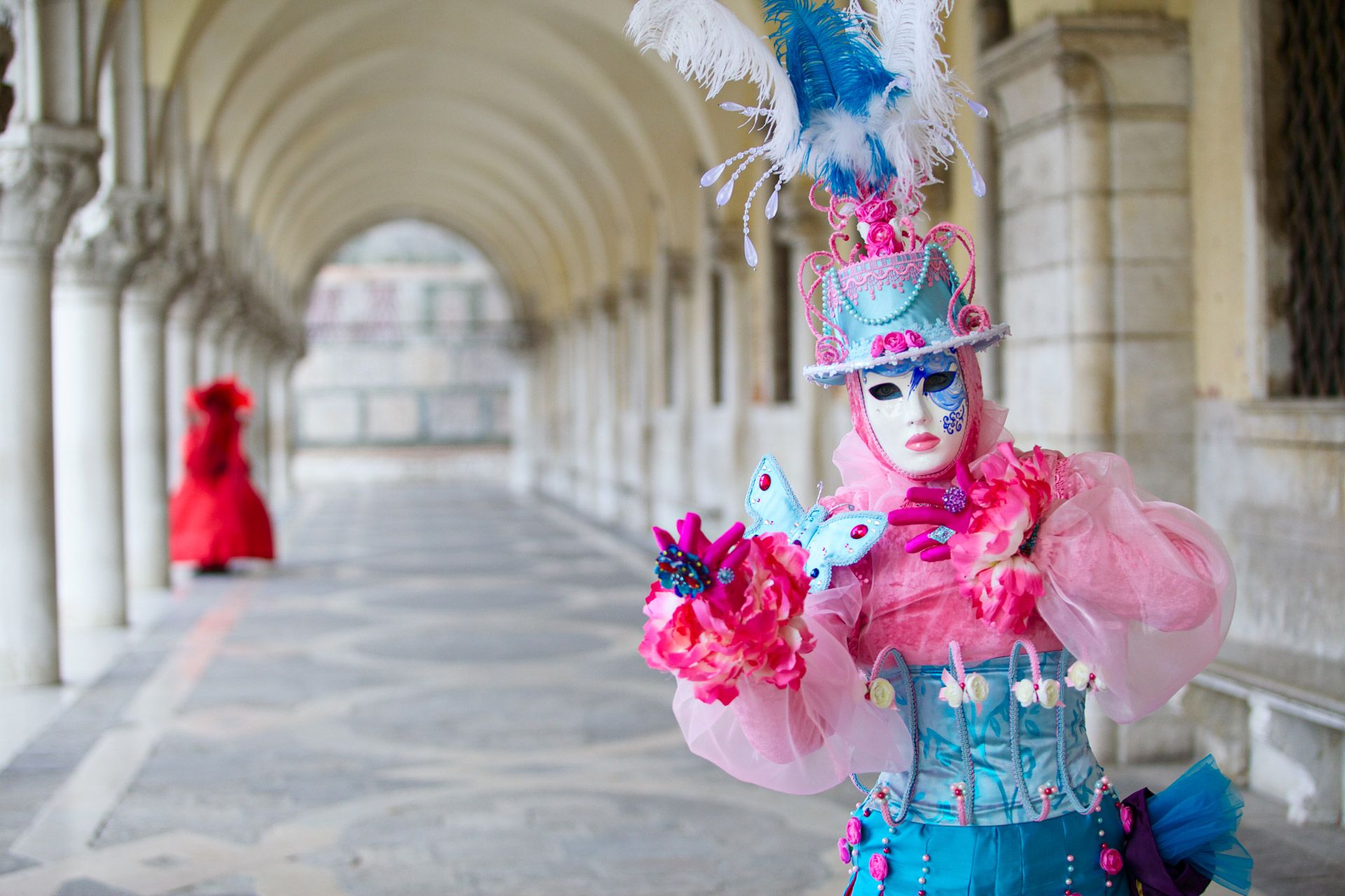 Mask posing under Doge's Palace during Venice carnival 2013