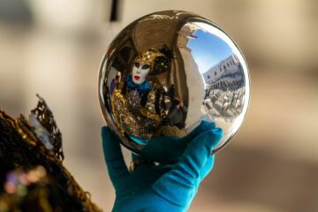 Mask at Venice carnival reflected on a sphere