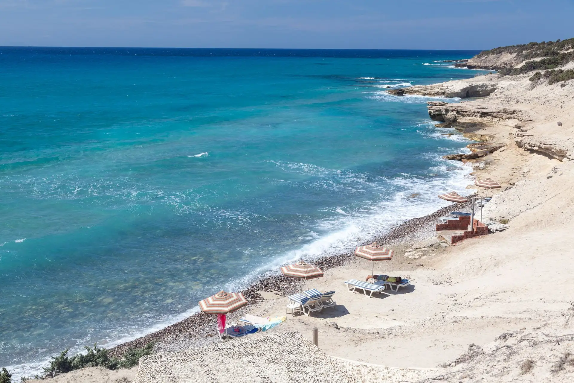 Quite beach in Kos island with a few umbrellas