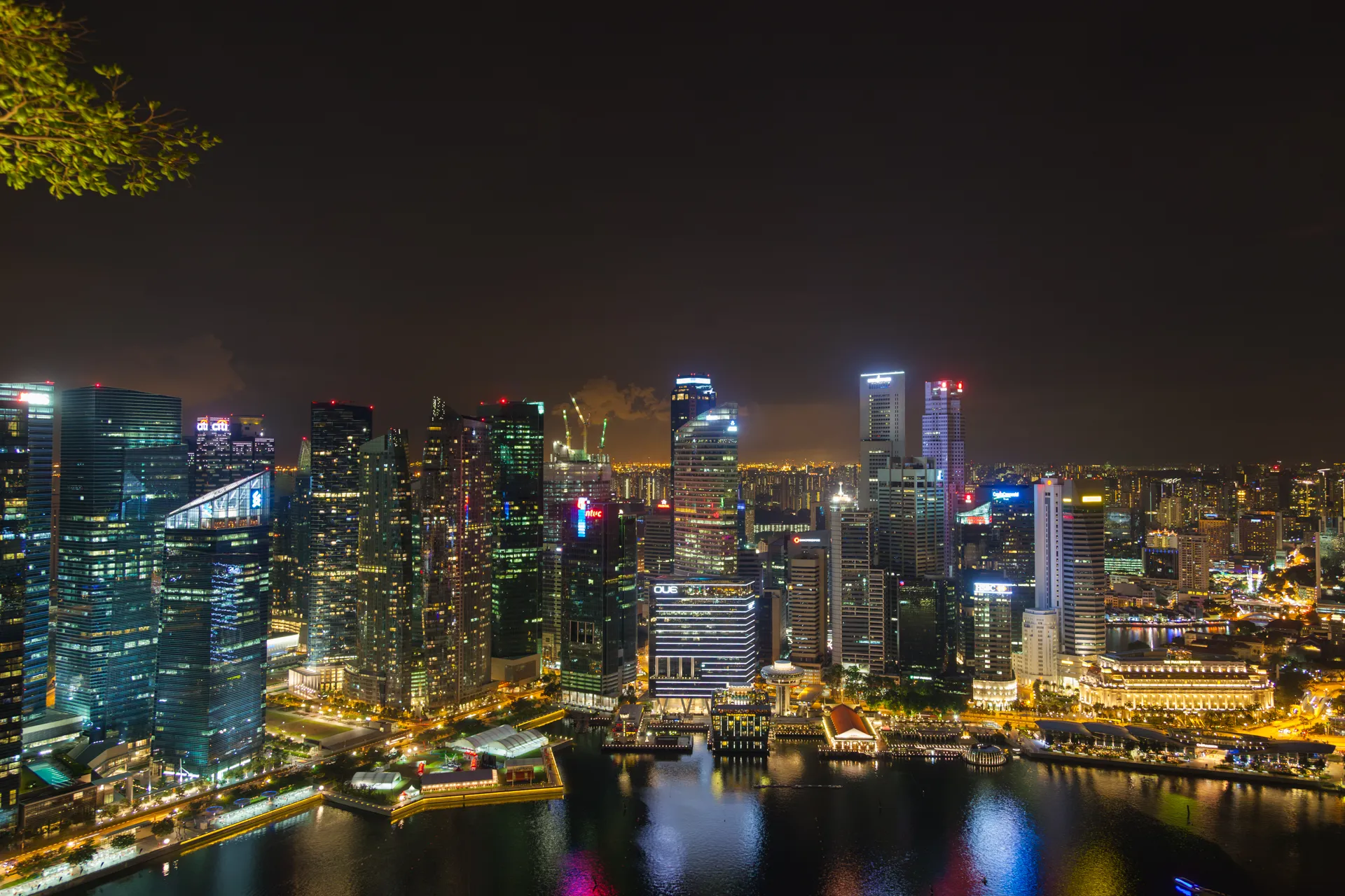 Skyline notturno di Singapore con riflessi colorati